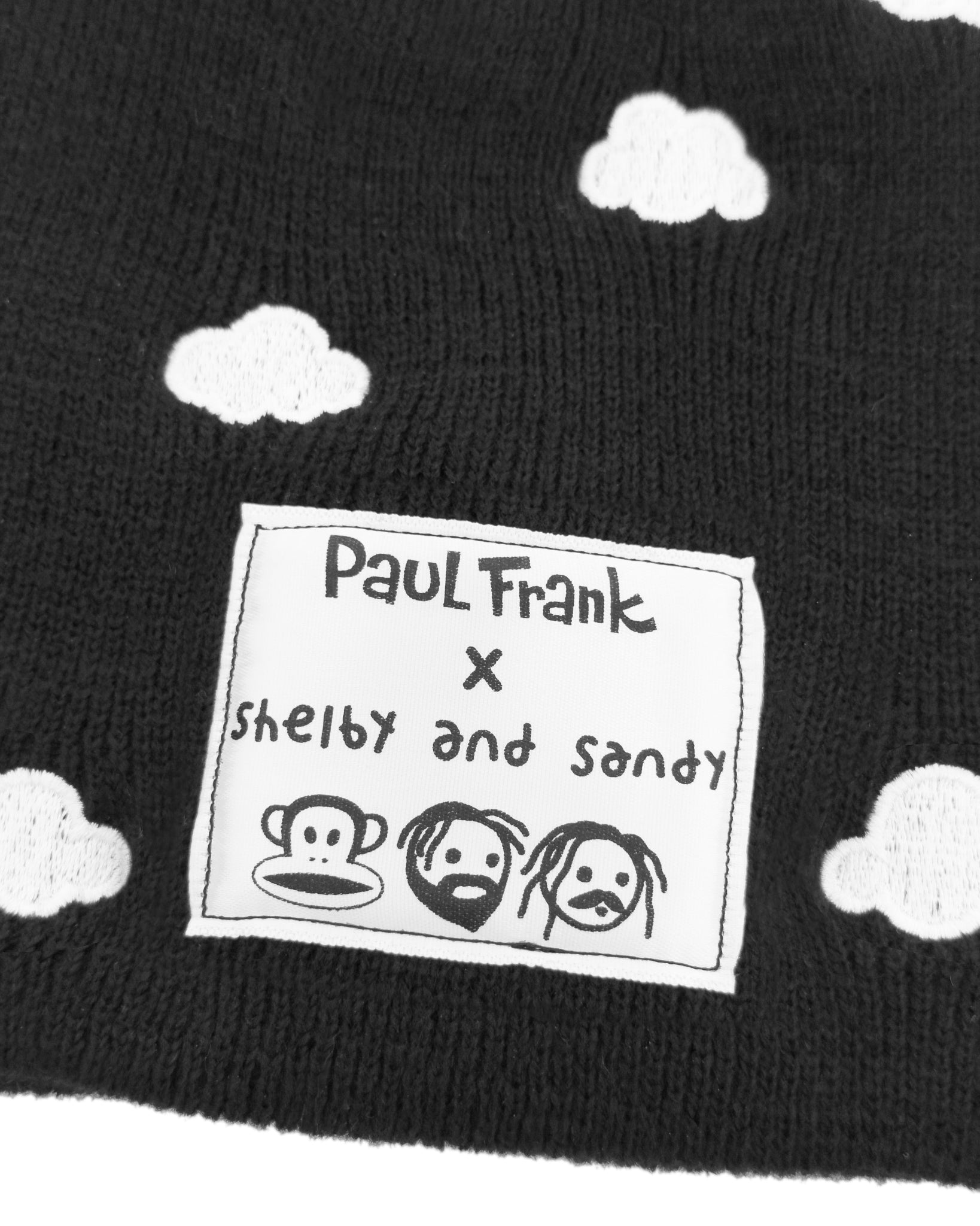 Black beanie with white cloud patterns and Paul Frank label